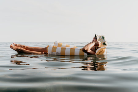 Person lying on an inflatable float in the water.の写真素材