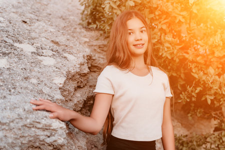 Portrait of a Smiling Teen Girl by a Rocky Outcropの写真素材