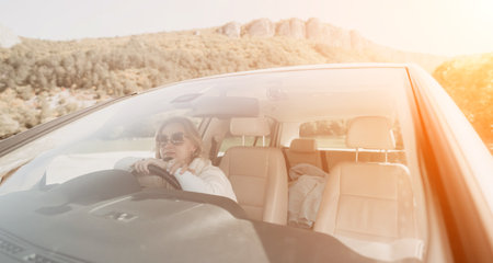 Woman Driver Car Sunlit Road Tripの写真素材