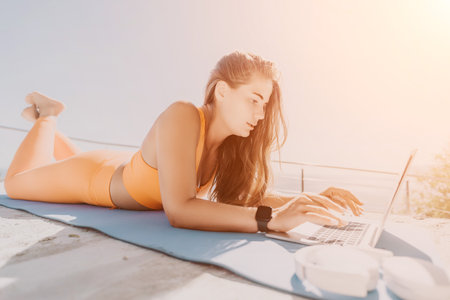 Woman Relaxing on a Beach, Working on a Laptop