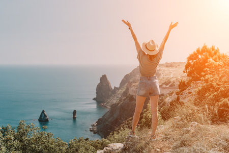 Woman in Hat Admiring the Seascapeの写真素材