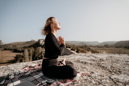 Woman Meditating on a Mountaintopの写真素材