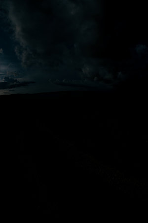 Dark Clouds Over a Silhouetted Landscape