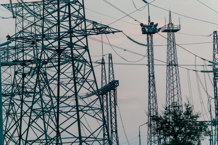Power Lines and Towers Against a Cloudy Skyの写真素材