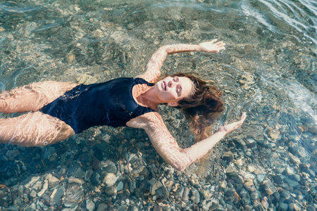 Woman Floating in Crystal Clear Water