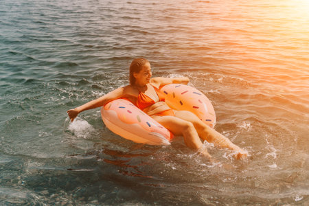 Woman Donut Float Water Summer Vacation Relaxing Funの写真素材