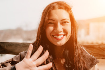 Woman Smiling Waving Hand Outdoor Portraitの写真素材