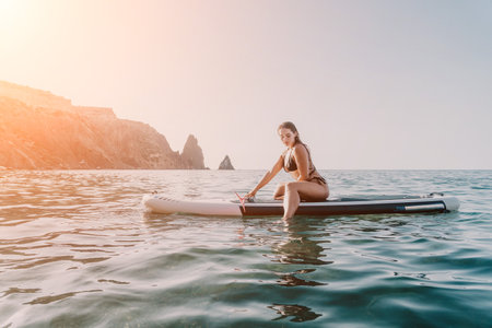 Woman Paddleboard Ocean Relaxing on Paddleboard in Sea During Summer Vacation.の写真素材