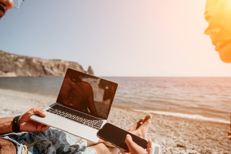 Laptop Beach Work Man using a laptop on a sunny beach.の写真素材