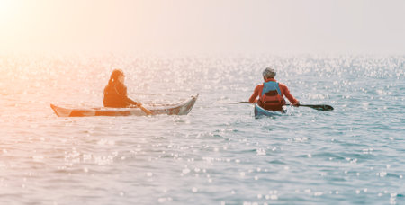 Kayaking Ocean Sunset Two People Kayaking on the Ocean at Sunset.の写真素材