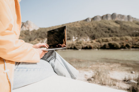 Woman Working on Laptop in Natureの写真素材