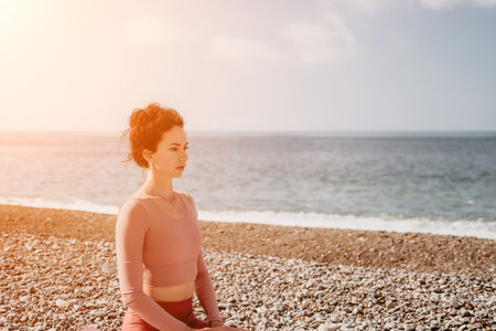 Woman sea pilates. Sporty happy middle aged woman practicing fitness on beach near sea, smiling active female training with ring on yoga mat outside, enjoying healthy lifestyle, harmony and meditationの写真素材