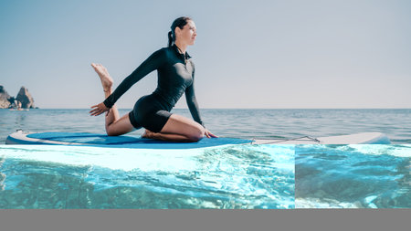 Yoga Paddle Board Ocean Woman practicing yoga on a paddleboard in the ocean.