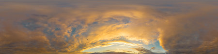 Golden glowing red orange overcast sunset sky 360 hdr panorama. Seamless spherical equirectangular panorama. Sky dome or zenith for 3D visualization and sky replacement for aerial drone 360 panoramasの写真素材