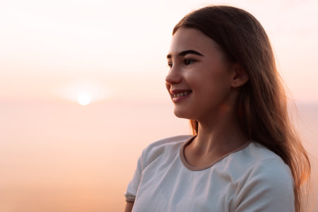 Smiling Woman at Sunset with a Blurry Backgroundの写真素材