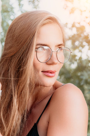 Woman Glasses Portrait Outdoor - Close-up portrait of a woman wearing glasses outdoors.の写真素材