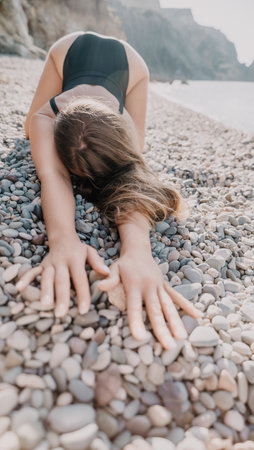 Woman in Black Swimsuit Posing on Pebblesの写真素材