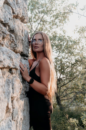 Woman Stone Wall Nature - Portrait of a woman standing next to a stone wall in a natural setting.の写真素材