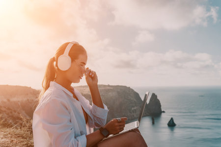 Woman Laptop Headphones Ocean View Sunset Workの写真素材