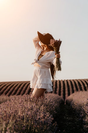 Woman in White Dress Standing in a Lavender Fieldの写真素材