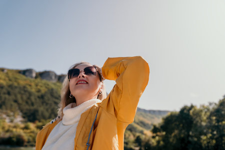 Woman in Yellow Raincoat Looking Up at the Skyの写真素材