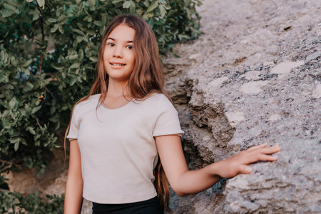 Girl Leaning Against a Rocky Cliffの写真素材