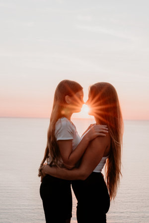 Two Women Embracing at Sunsetの写真素材