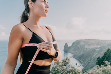 Woman Measuring Chest Outdoors Fitness Motivationの写真素材