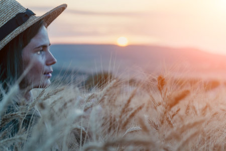 Woman Wheat Field Sunset: Contemplative portrait, rural setting, evening light.の写真素材