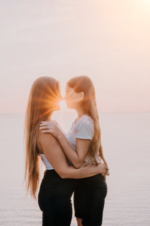 Mother and Daughter Embrace in Golden Sunsetの写真素材