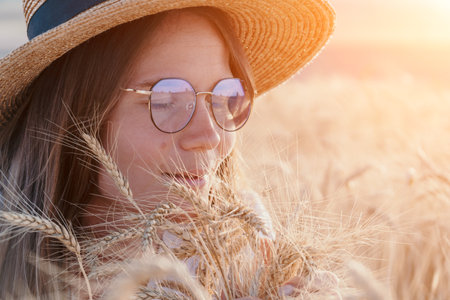 Woman Wheat Field Sunset: Summer portrait, enjoying natures beauty, golden hour.の写真素材