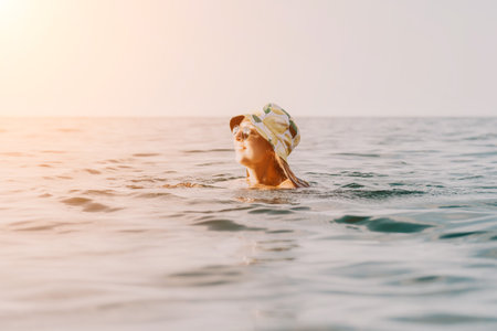 Woman Ocean Swimming - A woman swims in the ocean, enjoying the water and the scenery.の写真素材