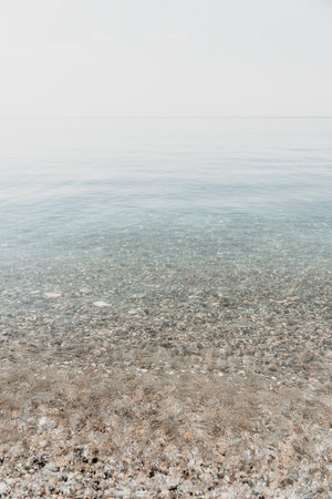 A calm body of water with a few rocks scattered throughout
