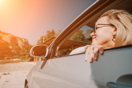 Woman Car Window Scenic View - Enjoying the view from a car window during a scenic drive.の写真素材