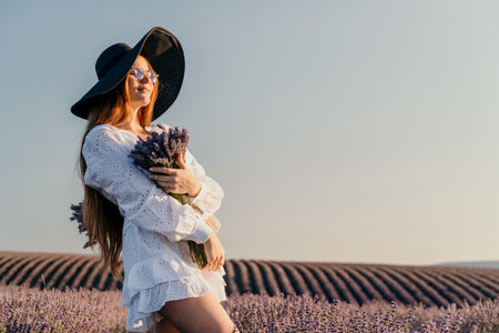 Woman in White Dress with Lavender Bouquet in a Fieldの写真素材