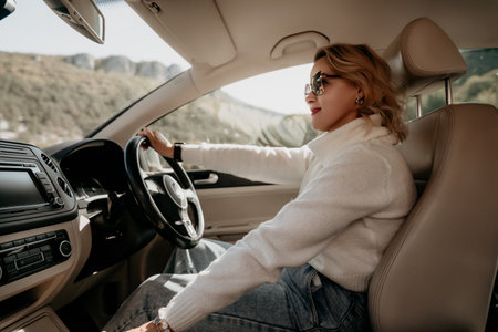 Woman in White Sweater Driving a Carの写真素材