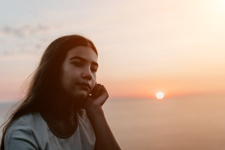Girl Contemplating at Sunsetの写真素材