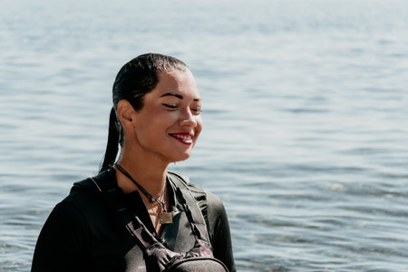 Woman Water Smiling Beach - A smiling woman is standing in the water on a beach.