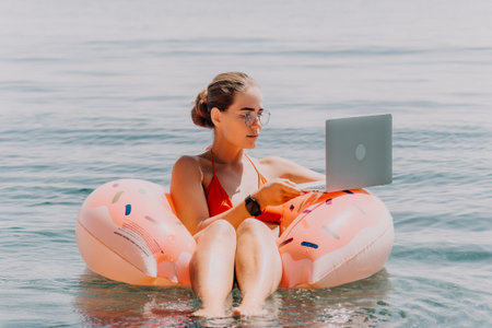 Woman Laptop Flamingo Float Beach Summerの写真素材