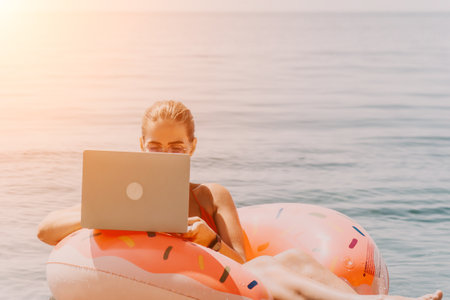 Woman Laptop Beach Working Remotely on Inflatable Float