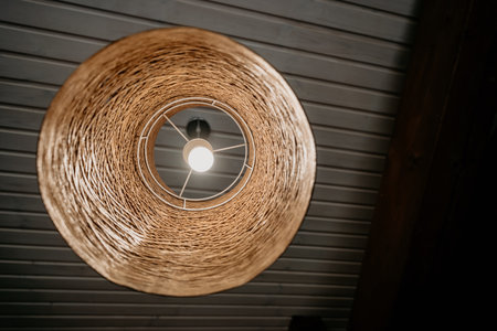 Wicker Pendant Lamp Hanging from Wooden Ceilingの写真素材