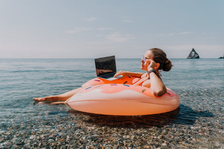 Woman Laptop Beach Working on Laptop While Floating on a Pool Float in the Ocean