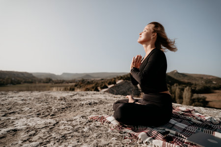 Woman Meditating on a Mountaintopの写真素材