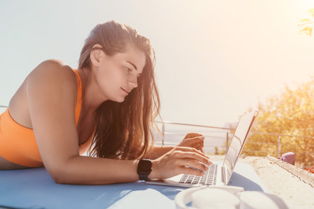 Woman Working on Laptop on a Sunny Dayの写真素材