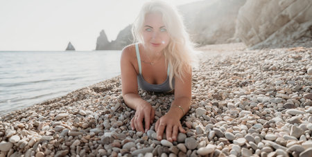 Woman Relaxing on a Pebble Beachの写真素材