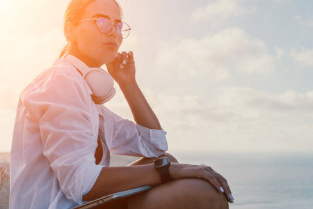 Woman sea laptop. Business woman, freelancer with laptop working over blue sea beach. Happy smiling...