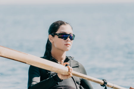 Woman Kayaking Sunglasses Water - Female paddler wearing sunglasses on a kayak on the water.の写真素材