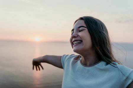 Joyful Girl at Sunsetの写真素材