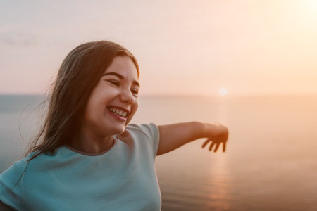 Laughing Girl at Sunset by the Seaの写真素材