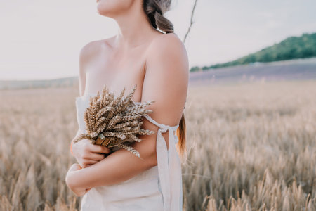 Woman in a Wheat Field Holding a Bouquetの写真素材